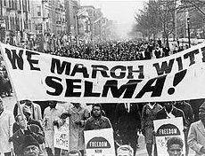 Marchers in New York marching in support of the Selma to Montgomery civil rights march in Alabama in 1965. February 22nd is the New Fire anniversary of the day 600 marchers in Alabama were stopped and attacked by police. Photo in Public Domain, via Wikimedia Commons.